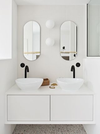 A white toned symmetrical bathroom