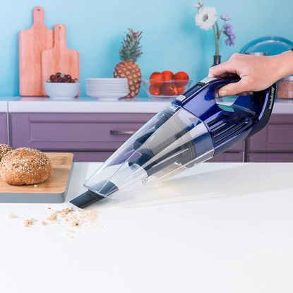 Image of Beldray Wet and Dry cordless hand vacuum during use in promotional photo in kitchen