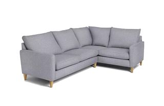 A small grey corner sofa with wooden legs
