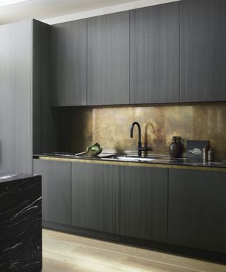 dark timber kitchen with metallic accents