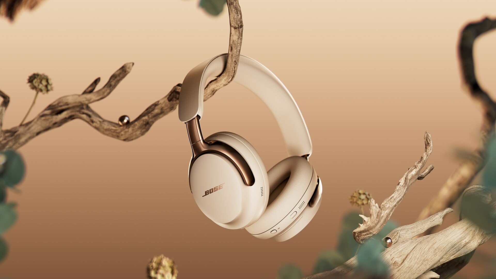 Bose QuietComfort Ultra Headphones (2nd Gen) in cream on a branch