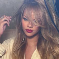 Rihanna with long blonde hair and side fringe
