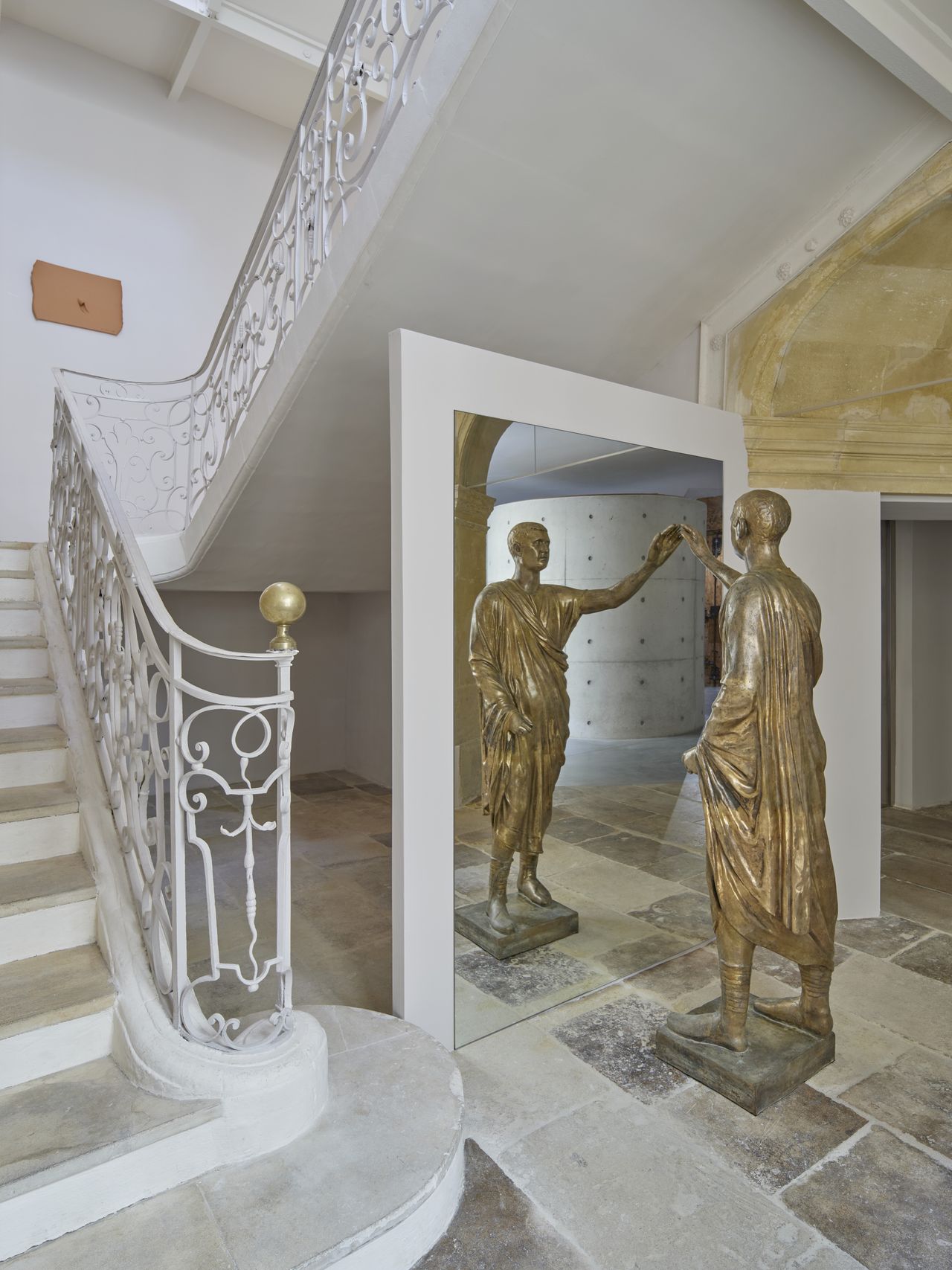 Installation shots of a painting and sculpture exhibition set within a palatial building.