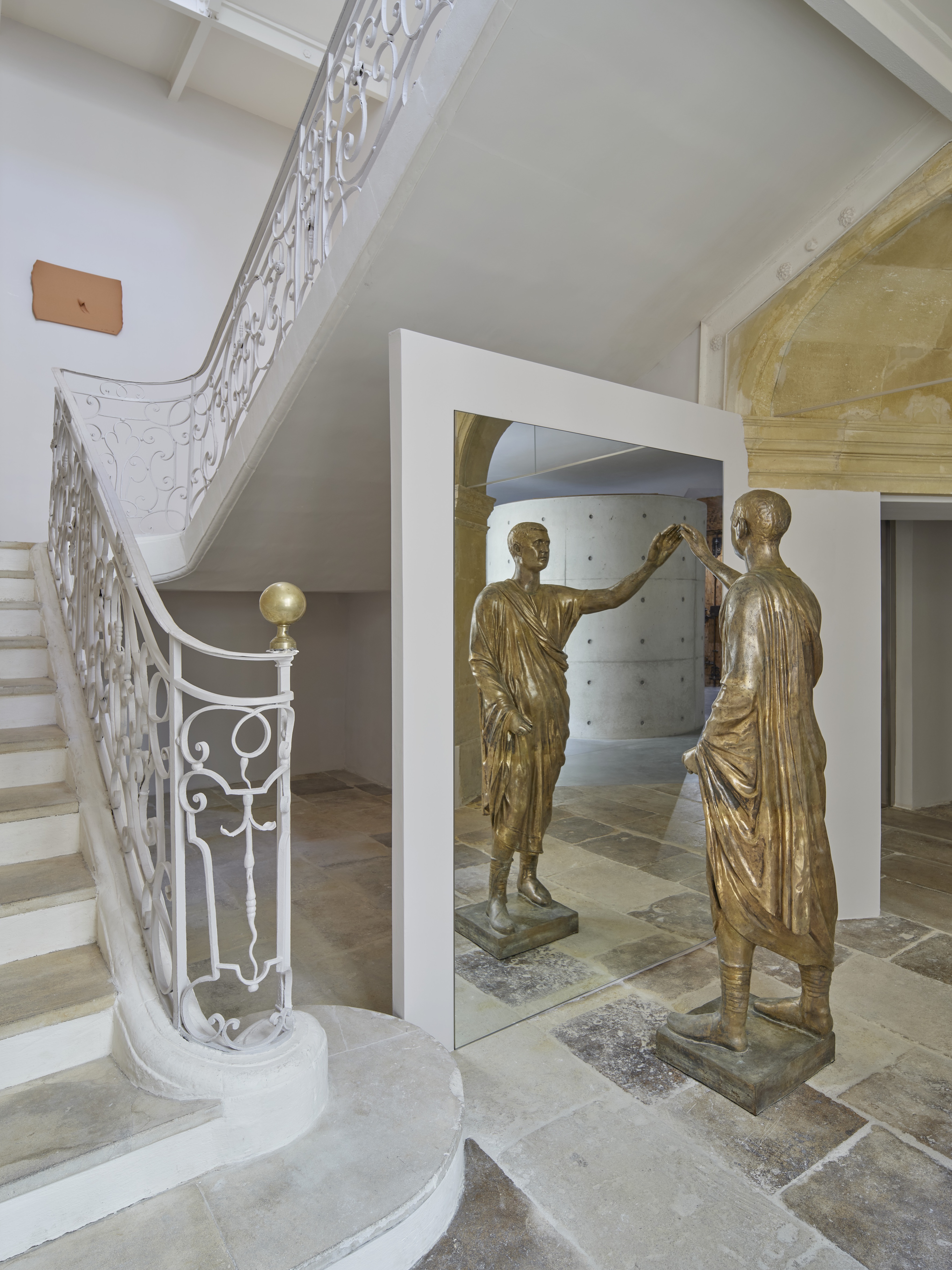 Installation shots of a painting and sculpture exhibition set within a palatial building.