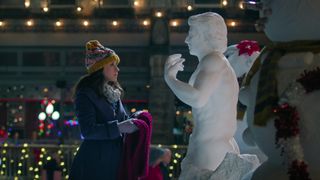 Lacey Chabert as Kathy Barrett talking to a snowman during the Netflix Christmas movie, Hot Frosty.