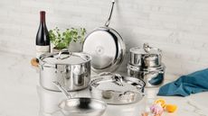 Hestan Probond Luxe series displayed on a marble counter, surrounded by wine and herbs