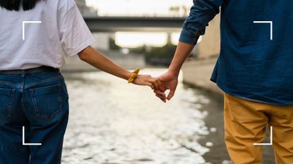 Couple holding hands by river