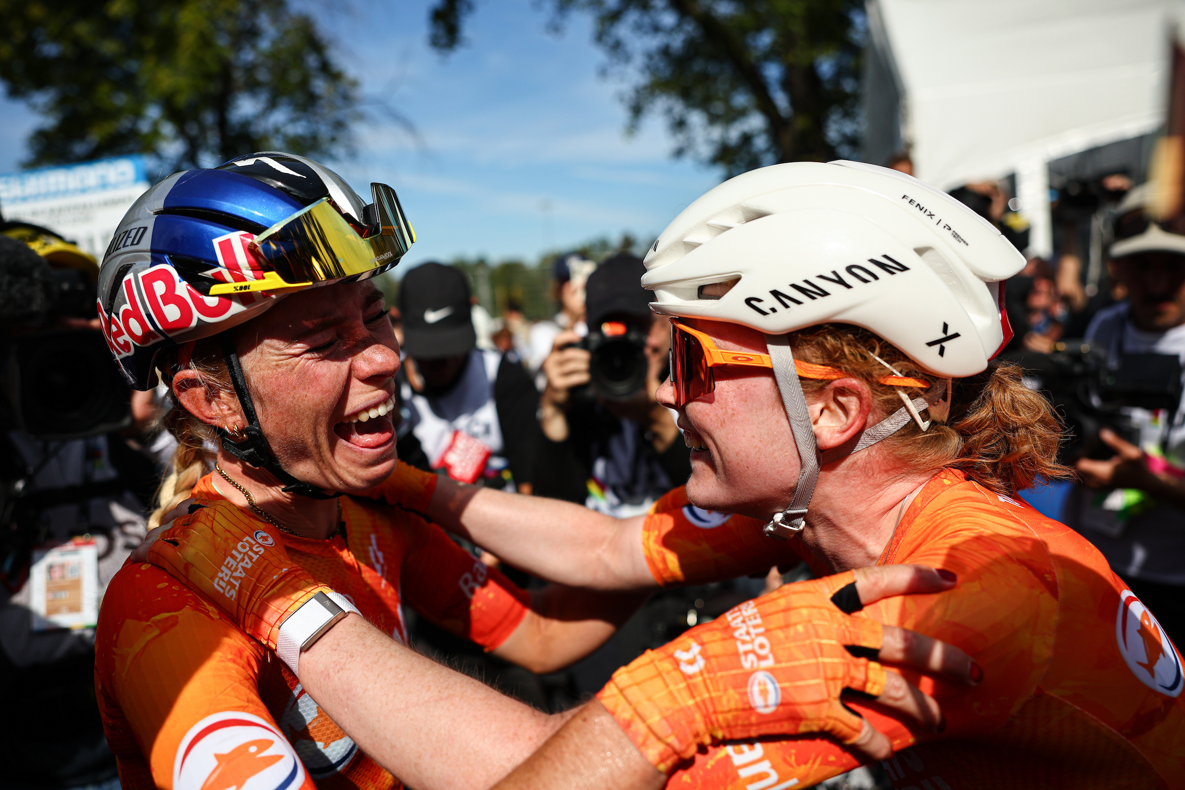 Demi Vollering celebrates with Puck Pieterse after winning the women's road race at the 2026 Road World Championships