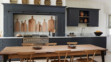 Black and white kitchen with wooden rectangle dining table and chairs