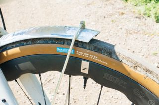 A tan gravel tyre on a pale gravel path