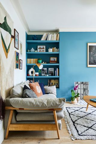 A modern living room with alcove and sky blue wall paint decor with cream berber-style rug