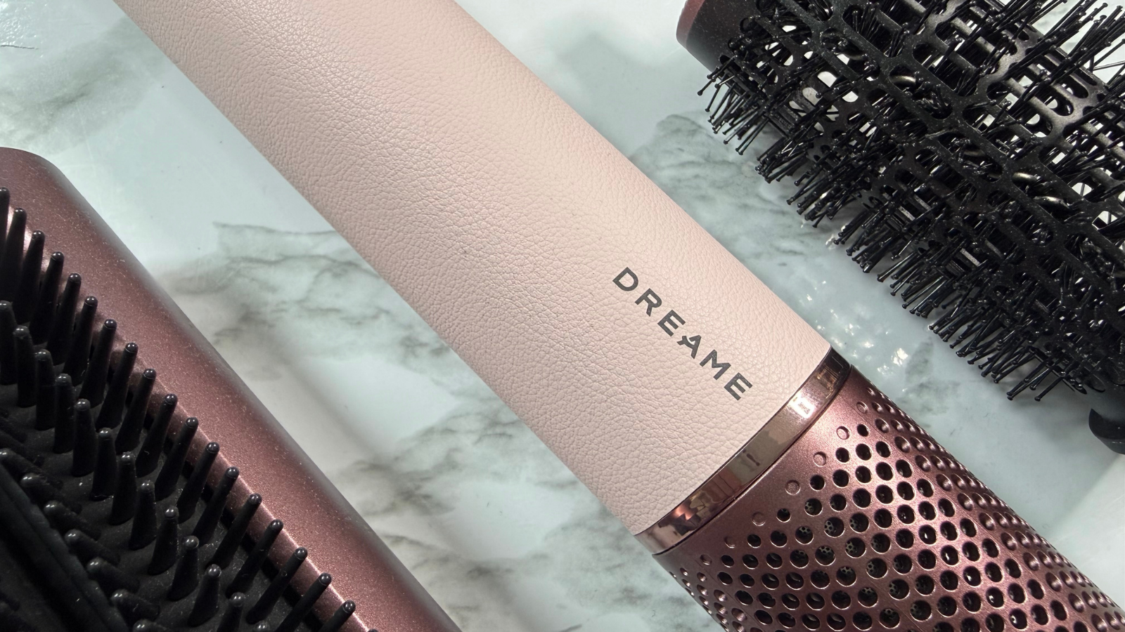 Close-up of the Dreame AirStyle Era branding, filter housing and styling brush attachments