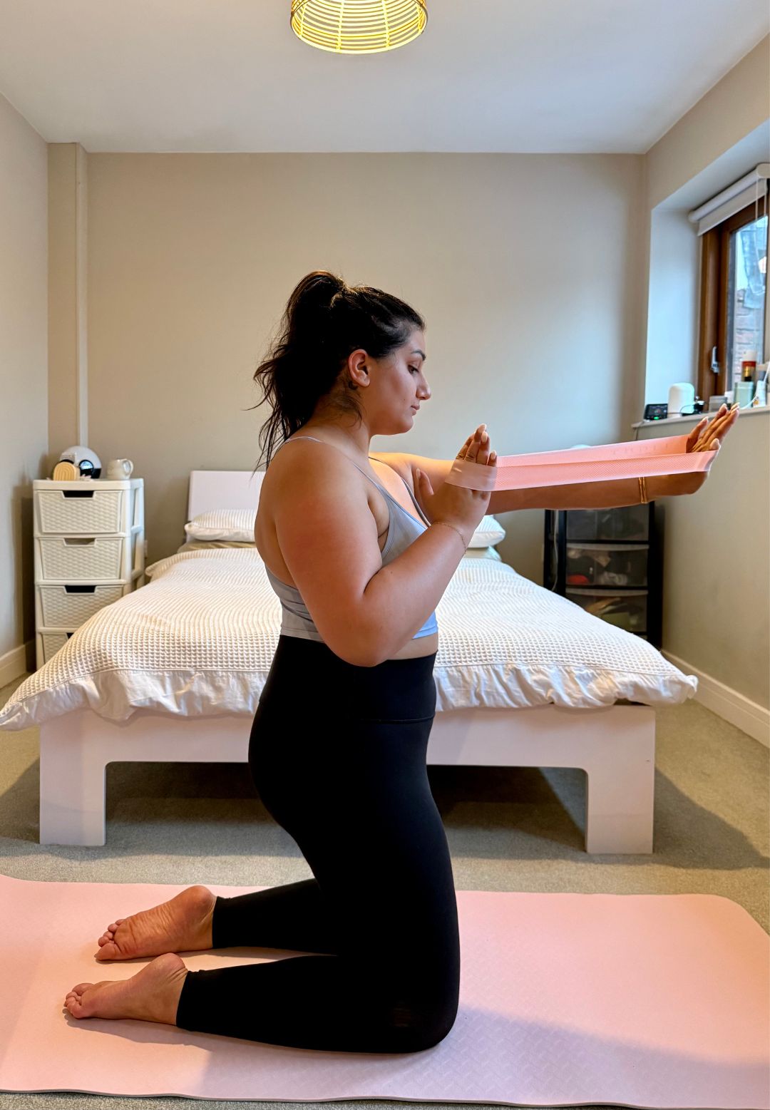 Nishaa during her at-home resistance band workout
