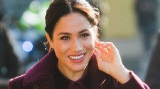 Meghan Markle smiling whilst walking outside