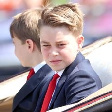 Prince George wears a navy suit and red tie to attend Trooping the Colour 2025
