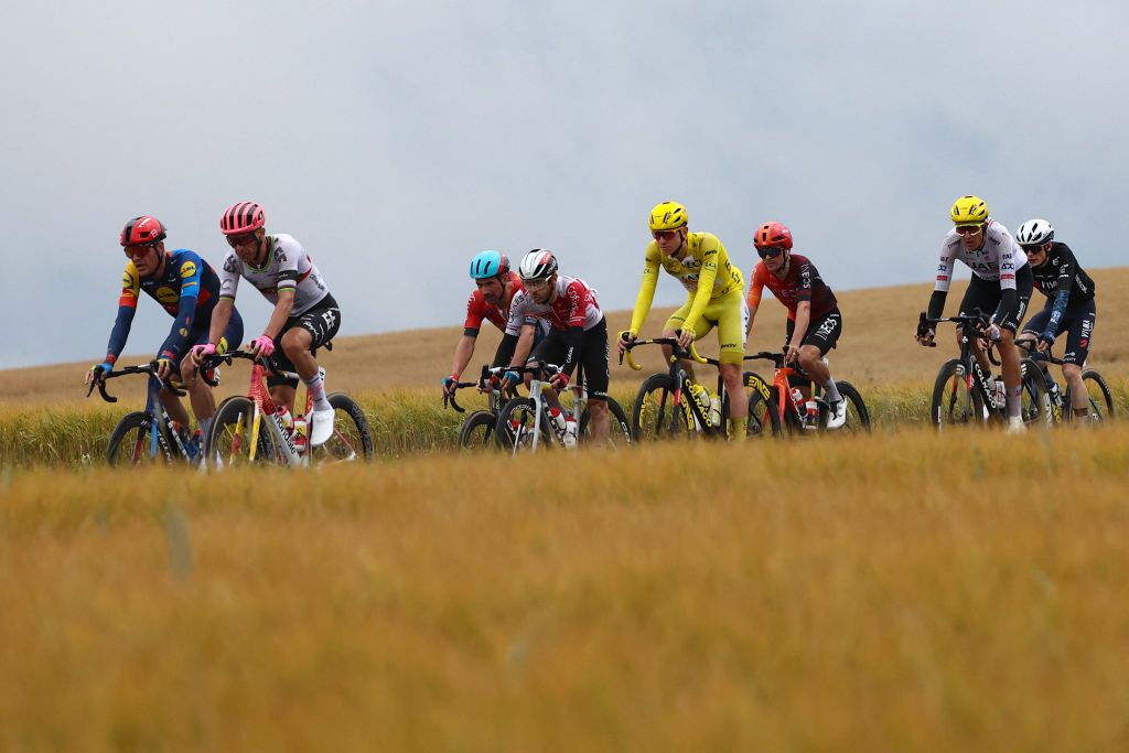 UAE Team Emirates team's Slovenian rider Tadej Pogacar wearing the overall leader's yellow jersey cycles with the pack of riders (peloton) during the 8th stage of the 111th edition of the Tour de France cycling race, 183,5 km between Semur-en-Auxois and Colombey-les-deux-Eglises, on July 6, 2024. (Photo by Anne-Christine POUJOULAT / AFP)