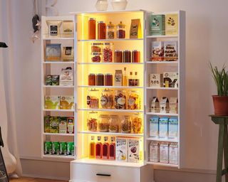Lit-up pantry with open doors and food inside