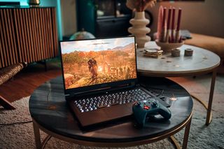 AERO 17 HDR laptop on coffee table with gaming controller