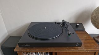 The Victrola Hi-Res Onyx record player on a wooden surface.