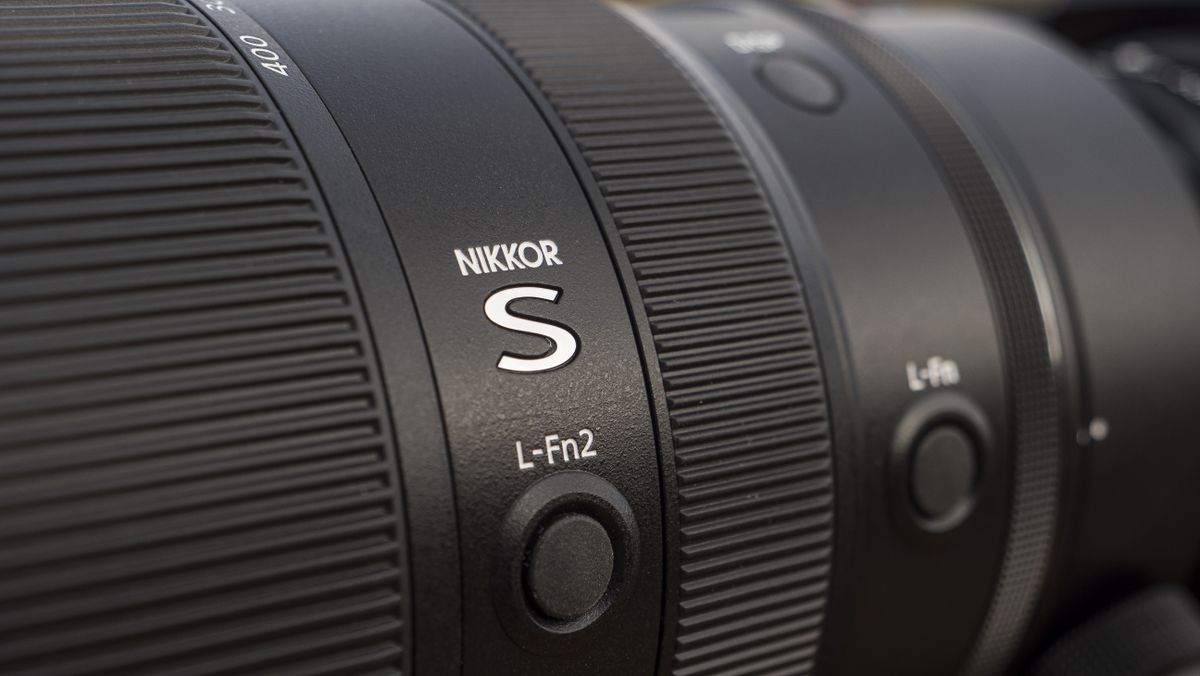 A Nikon Z telephoto lens on a wooden table