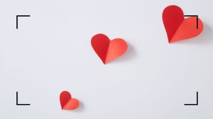 a trail of red paper hearts on a white background, to illustrate the love horoscope 2022 list