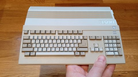 A photo of the A500 Mini for review, held over a wooden table