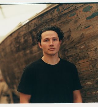 Marc Sweeney, photographed by Norman Wilcox-Geissen, in his father’s boatyard in Loch Lomond, with his ‘Pylon’ spun aluminium candleholders