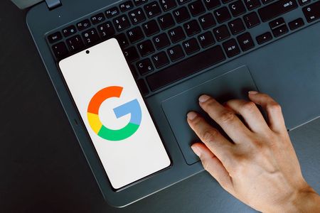 In this photo illustration, the Google logo is displayed on a smartphone screen