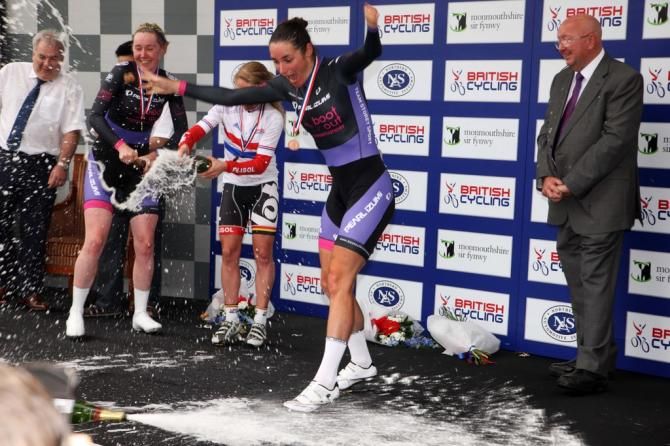Dame Sarah Storey drops the champagne on the podium