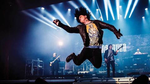 Steve Hogarth leaping in the air on stage with Marillion
