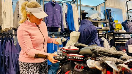 Carly Frost looking at putters