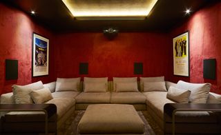Home cinema with red walls and plush furnishings