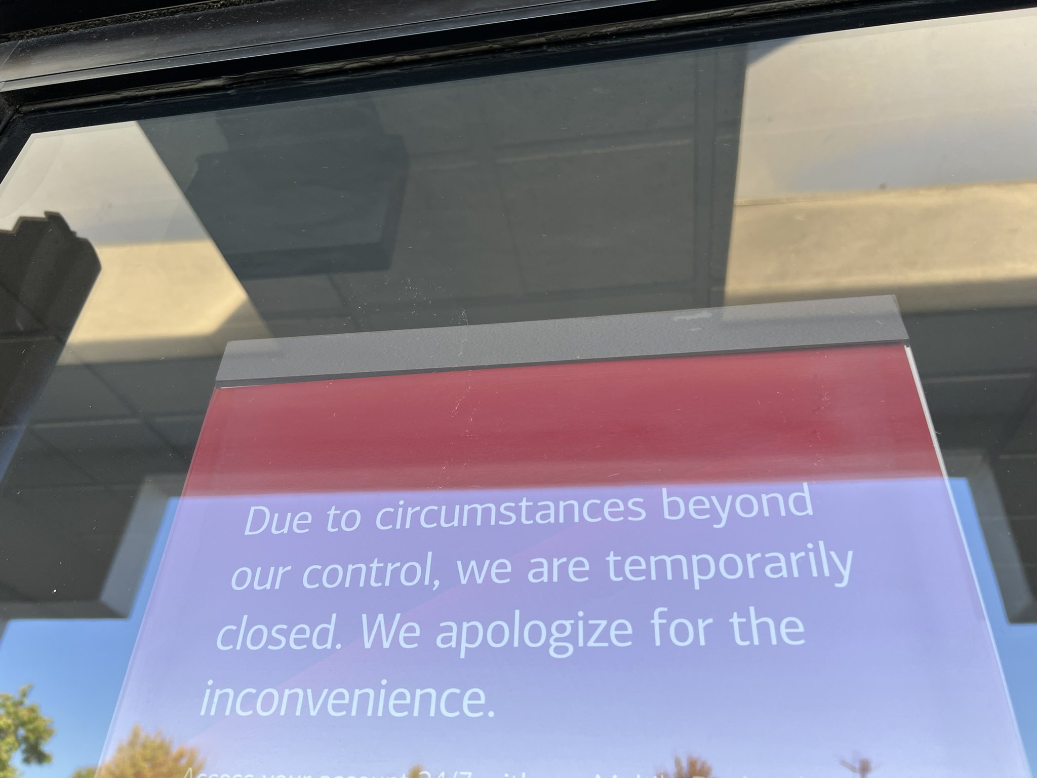 A sign outside a Bank of America location says it is temporarily closed due to the power outage