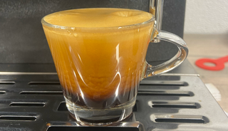 a photograph of an espresso shot poured on the kitchenaid semi automatic espresso machine with burr grinder