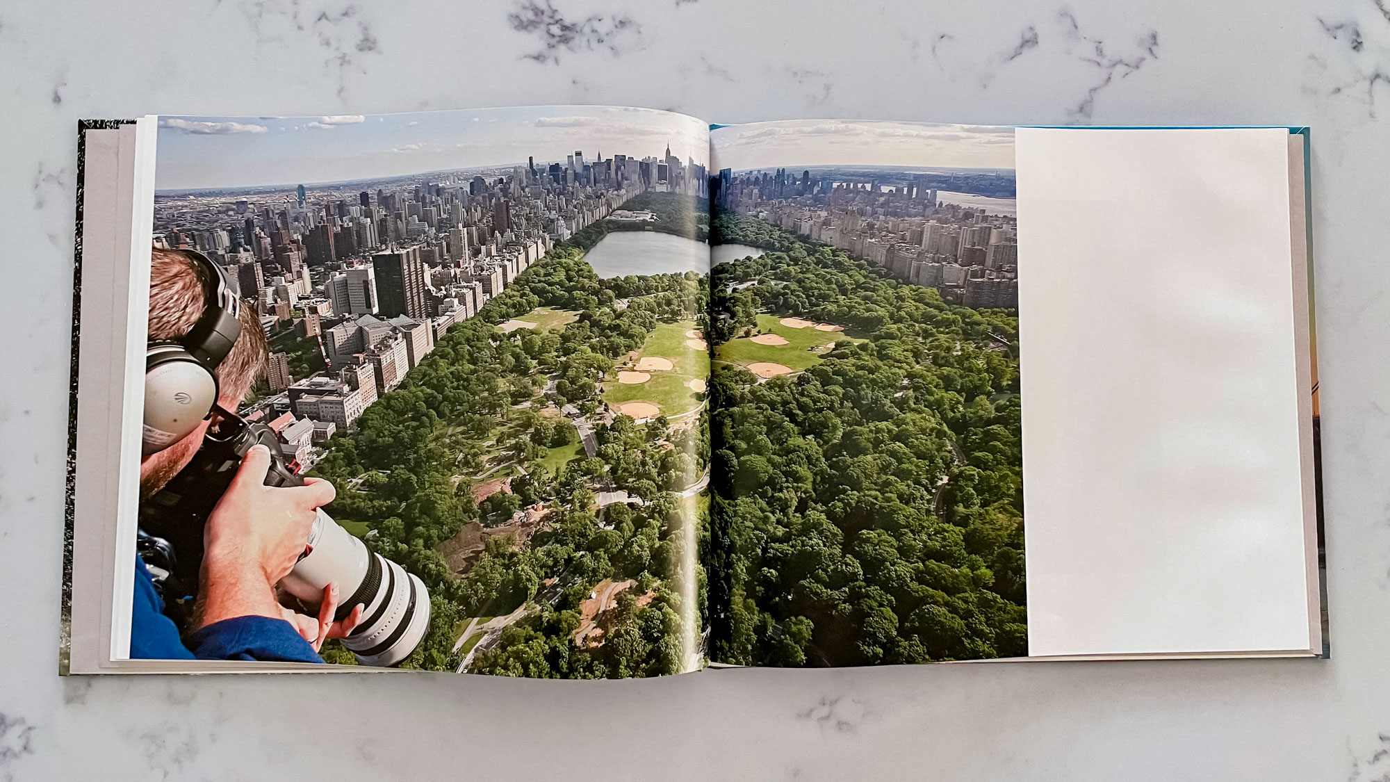 A Blurb photo book open on a countertop surface