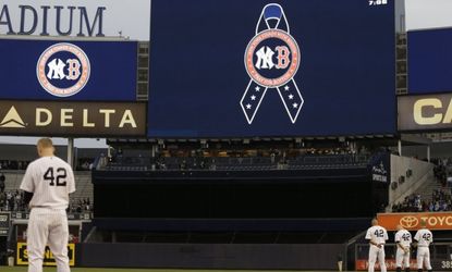 New York Yankees players observe a moment of silence before a game against the Arizona Diamondbacks at Yankee Stadium on April 16. 