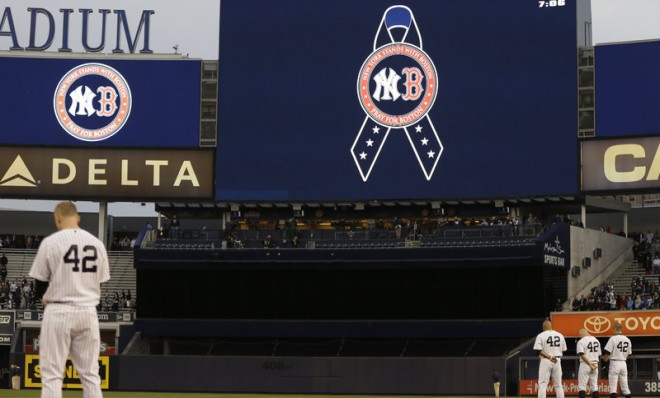 New York Yankees players observe a moment of silence before a game against the Arizona Diamondbacks at Yankee Stadium on April 16.