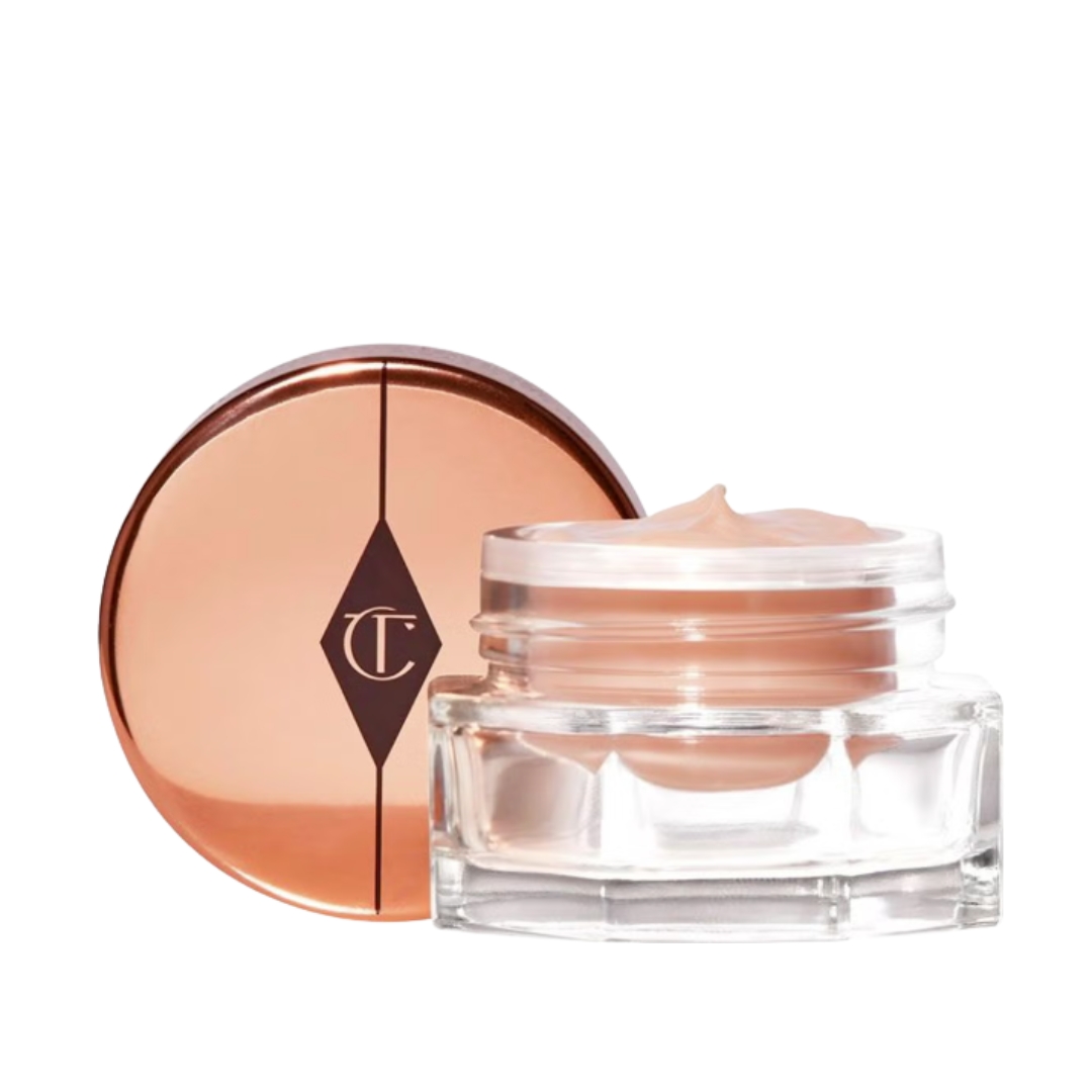 A product shot of the Charlotte Tilbury Charlotte's Magic Eye Rescue and it's lid/ on a white background