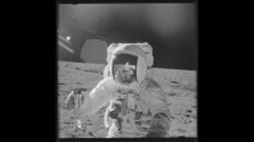 An Apollo 12 astronaut takes "moonshots" with a Hasselblad camera.