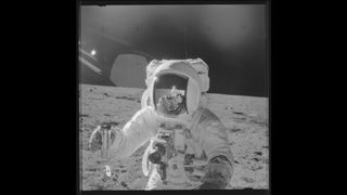 An Apollo 12 astronaut takes "moonshots" with a Hasselblad camera.