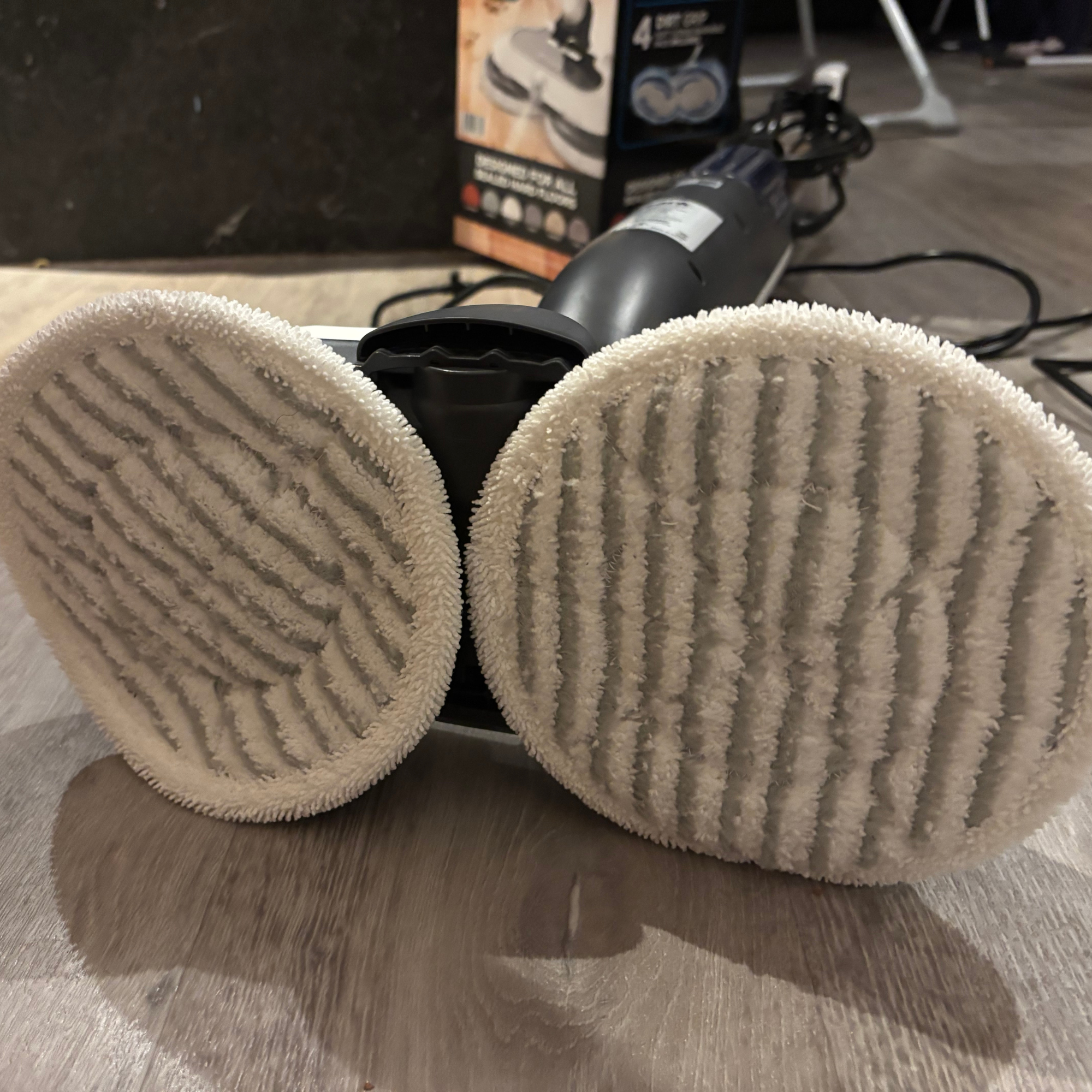 Underneath view of Shark Steam & Scrub on floor showing 2 x white mop pads