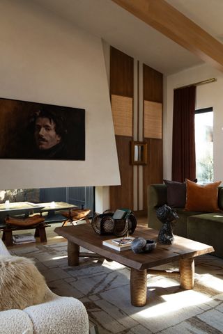 A living room with taupe walls, brown accents, and a wooden coffee table