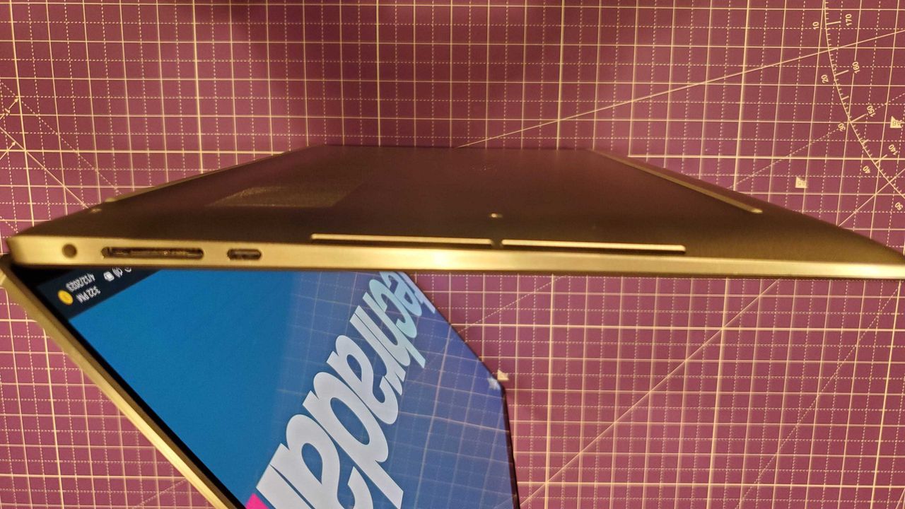 silver laptop sitting on purple desk