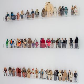 Transparent floating shelves displaying toy action figures