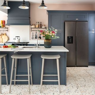 blue kitchen with island and stools