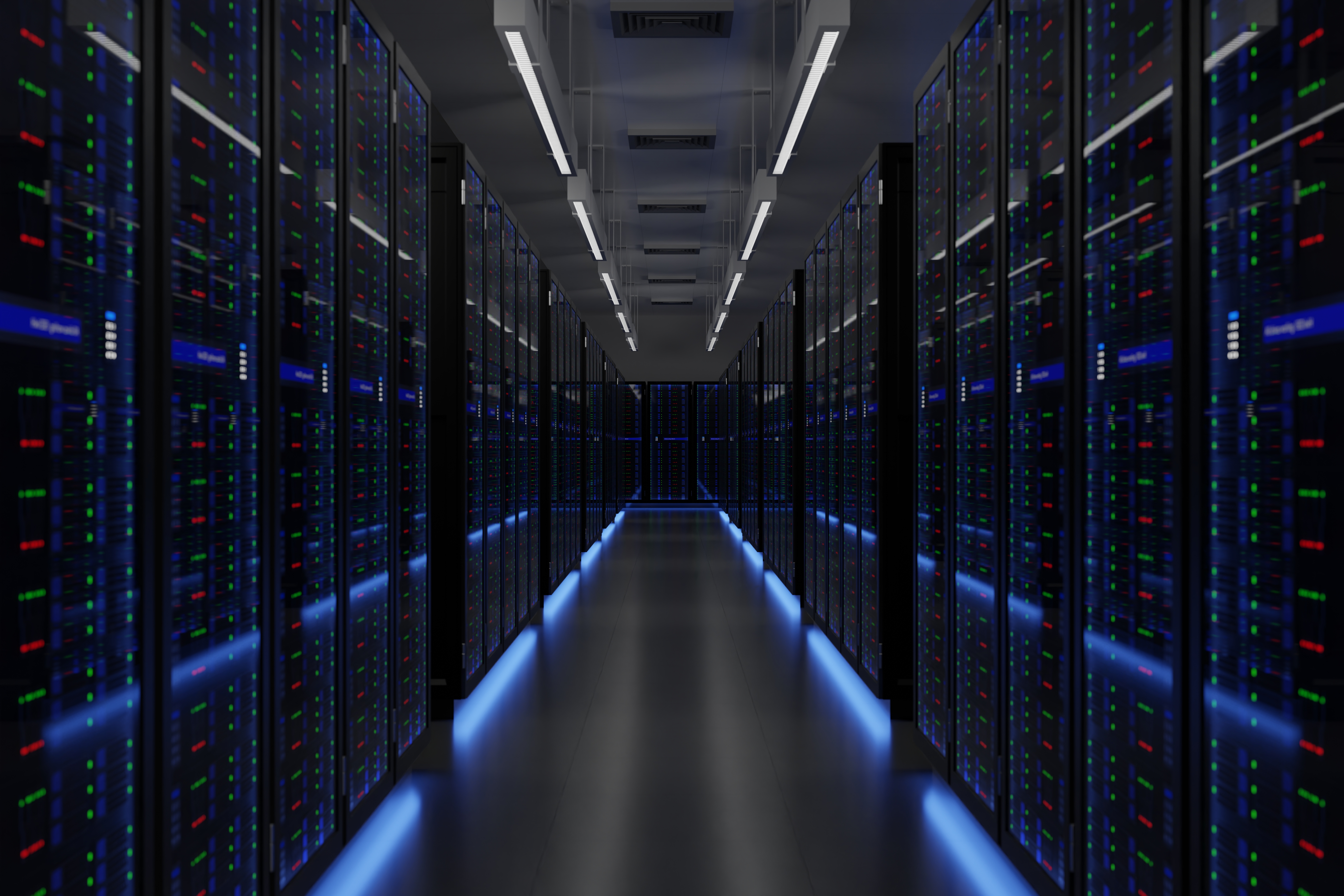 Data centers stock image showing inside of a darkened server room with blue neon lights.