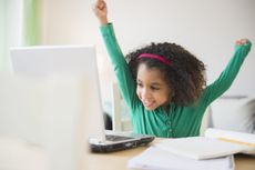 Child using a laptop at home