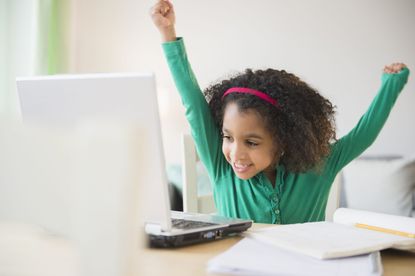 Child using a laptop at home