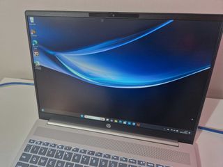 A silver HP Pavilion 16 sitting on a white desk