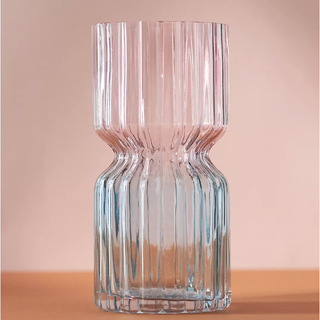 hourglass shaped ridged vase in a pink and blue tinted ombre design